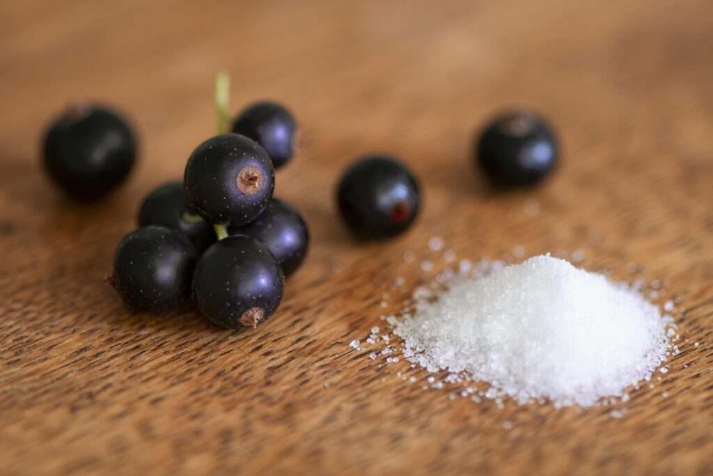 pexels-photo-1263313-1263313 Close-up of fresh black currants and salt on a wooden surface, highlighting texture and contrast.